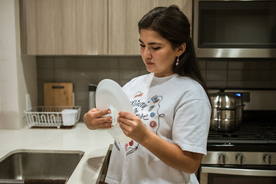 Cleaner meticulously wiping a kitchen counter